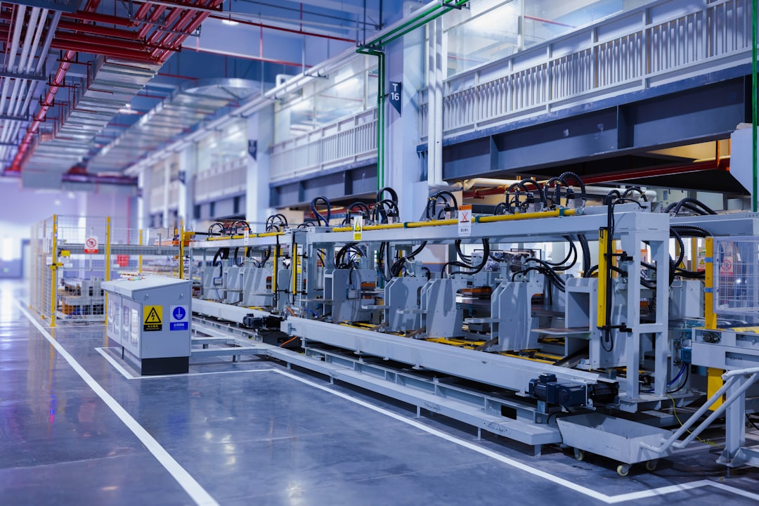 A view of the refrigerator manufacturing plants fully automated side panel forming line.Translation: Warning:Danger Prohibit reach into;elecric shock;must connect an earth terminal to the ground