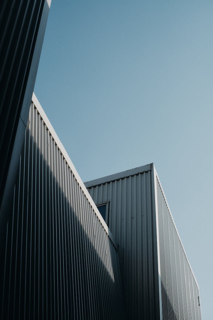 A contemporary building design showcasing modern architecture and abstract elements under a clear sky.